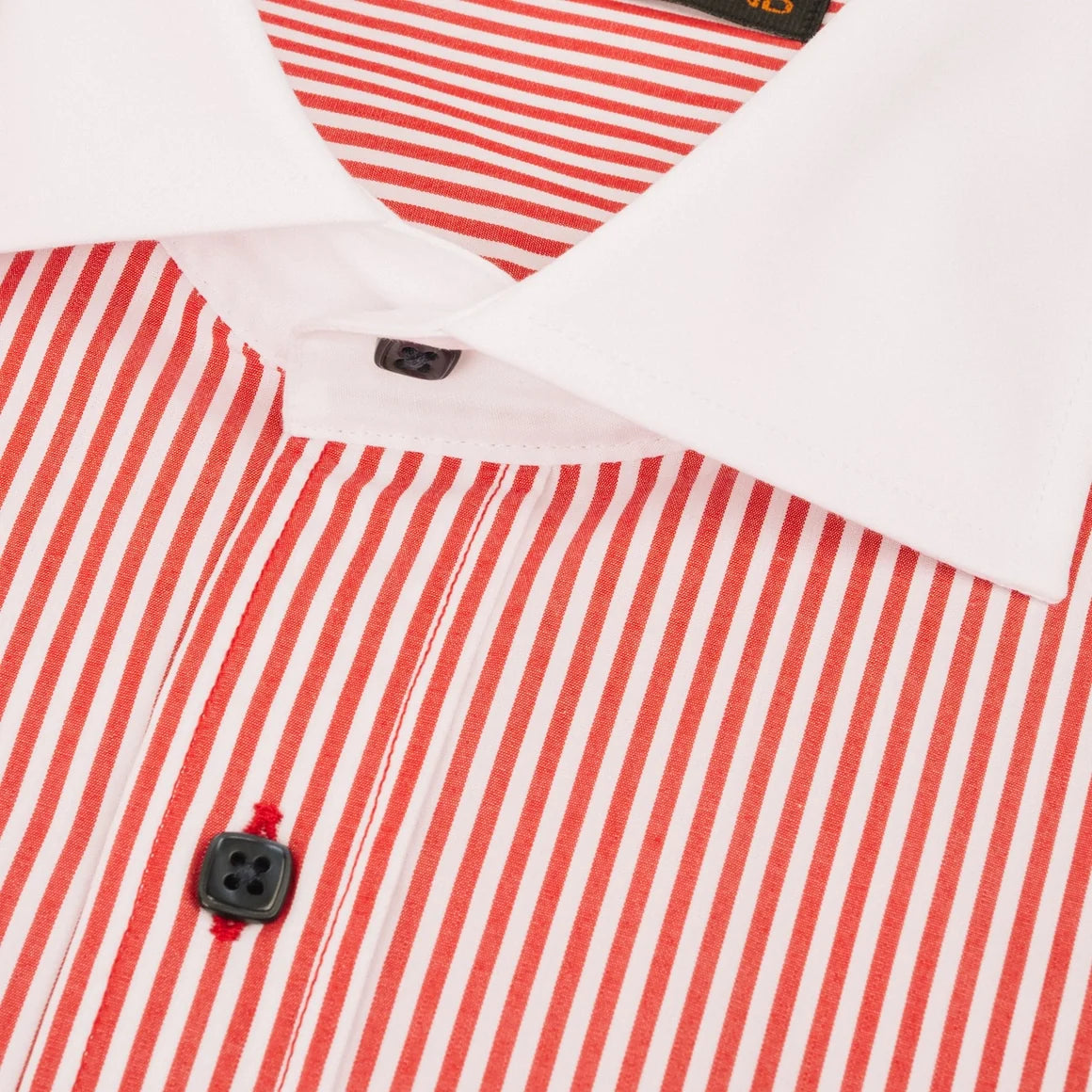 Close-up of a red and white striped dress shirt with a solid white collar and black buttons.