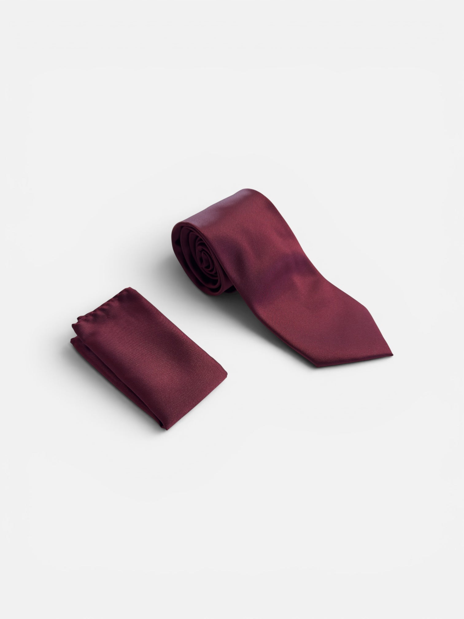 A Burgundy satin necktie and matching pocket square set, displayed on a clean white background.