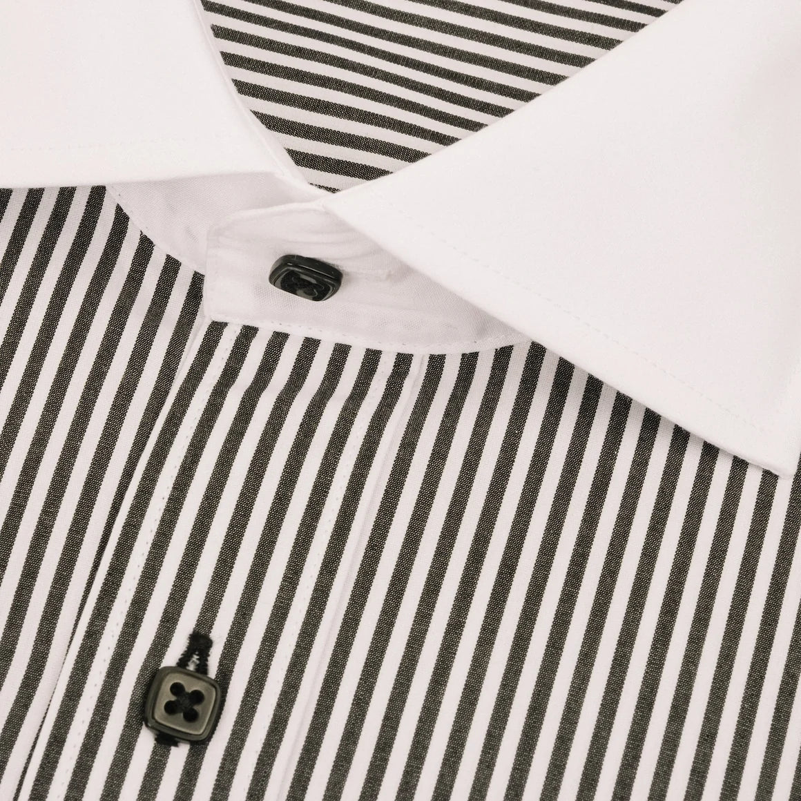 Close-up of a collared shirt with a white collar and black-and-white vertically striped body, featuring black buttons.