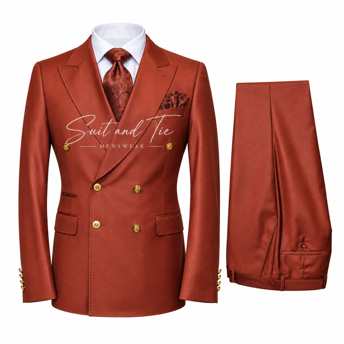 A men's double-breasted suit set in a rust-orange color, featuring a jacket on a white shirt with a patterned tie and pocket square, and matching trousers displayed alongside. The suit has gold buttons and a satin sheen.
