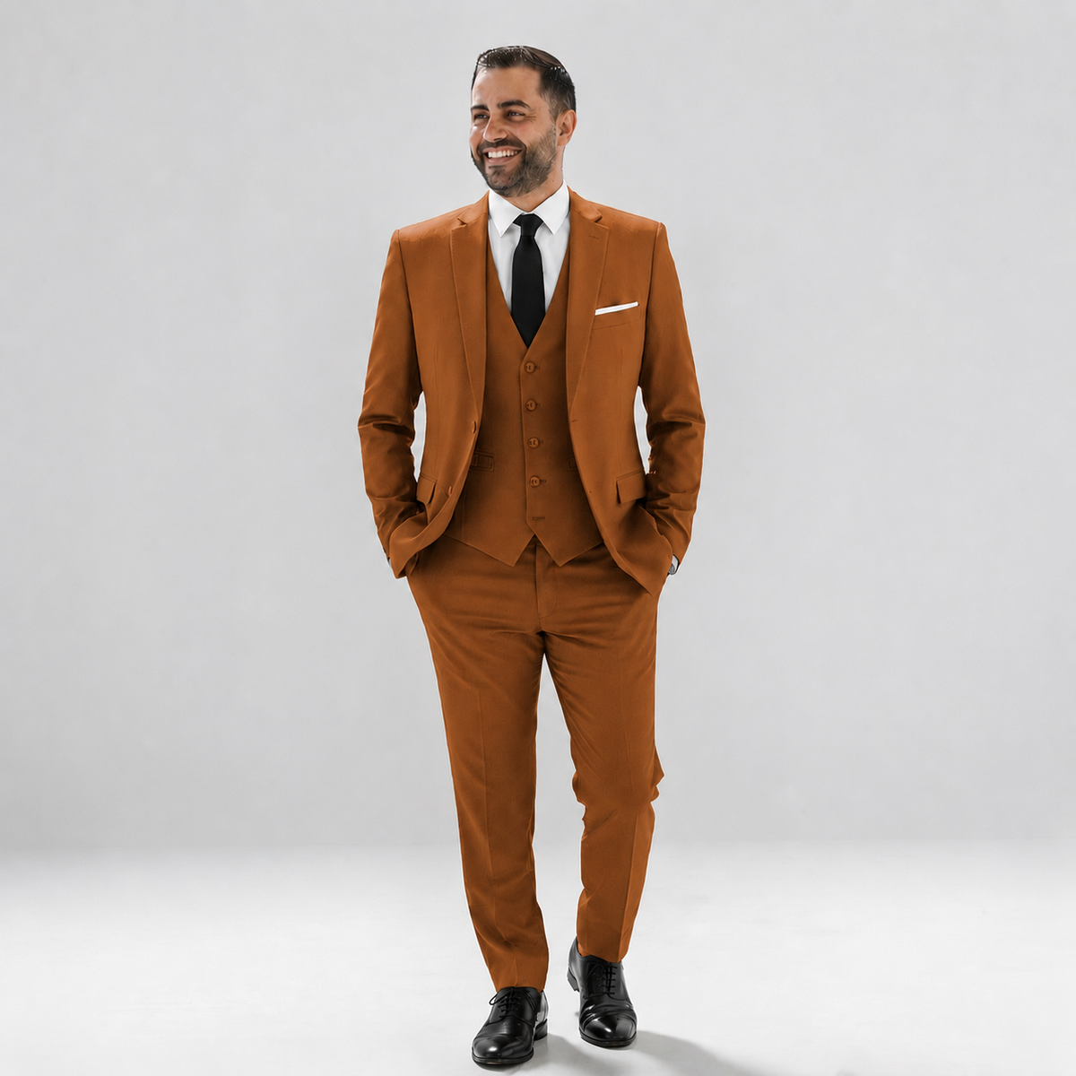 Man wearing a rust suit with a black tie on a white background