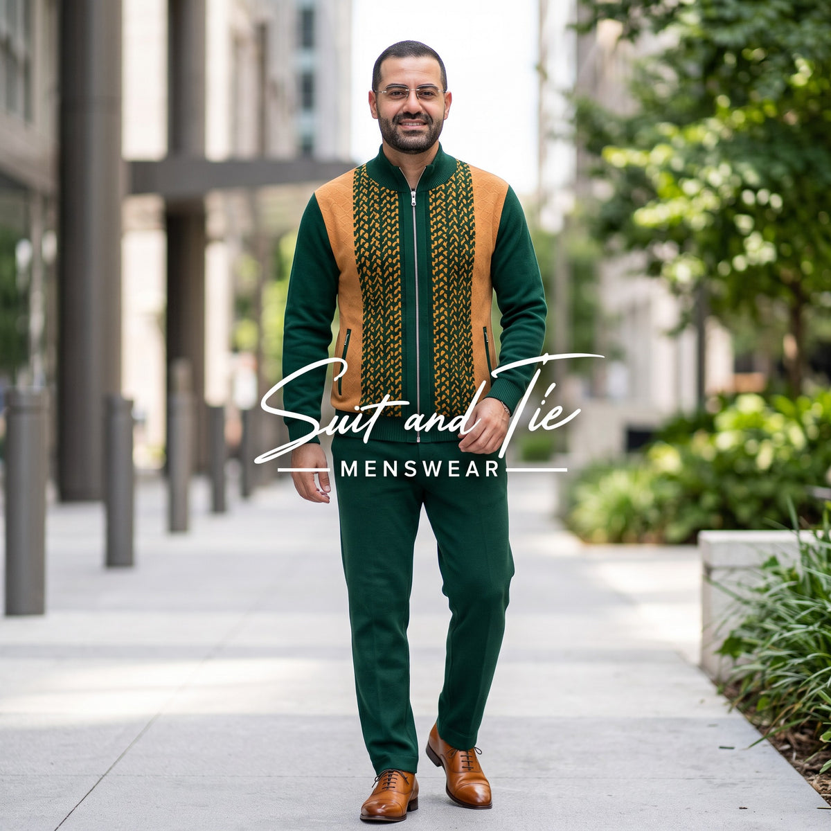 A man wearing a green and gold traditional-style suit with a patterned vest and matching trousers, walking on an outdoor urban sidewalk. The image features a 'Suit and Tie Menswear' watermark overlay.