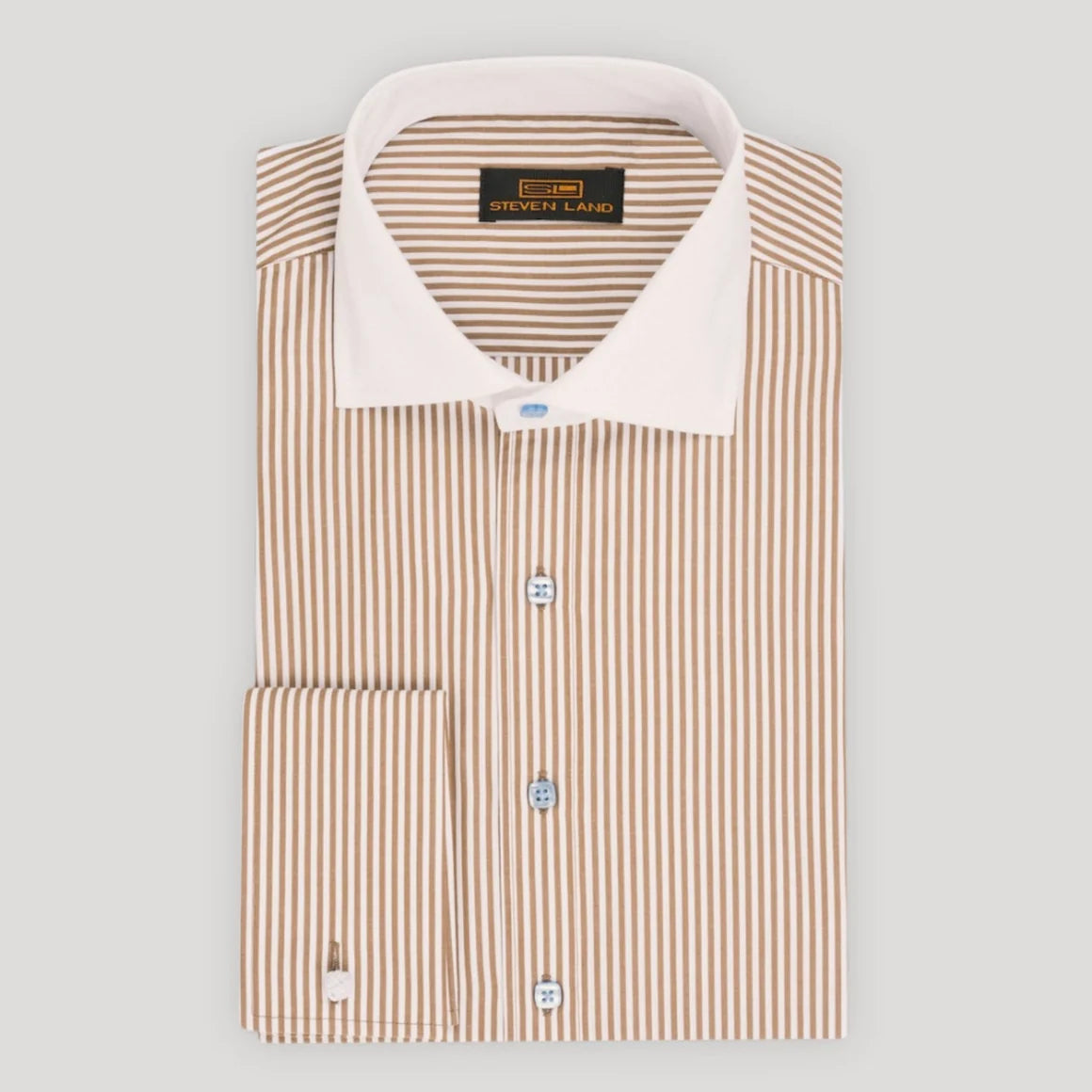 A folded long-sleeve dress shirt by St. John & Sons, featuring a vertical stripe pattern in beige and white, with a solid white collar and light blue buttons.